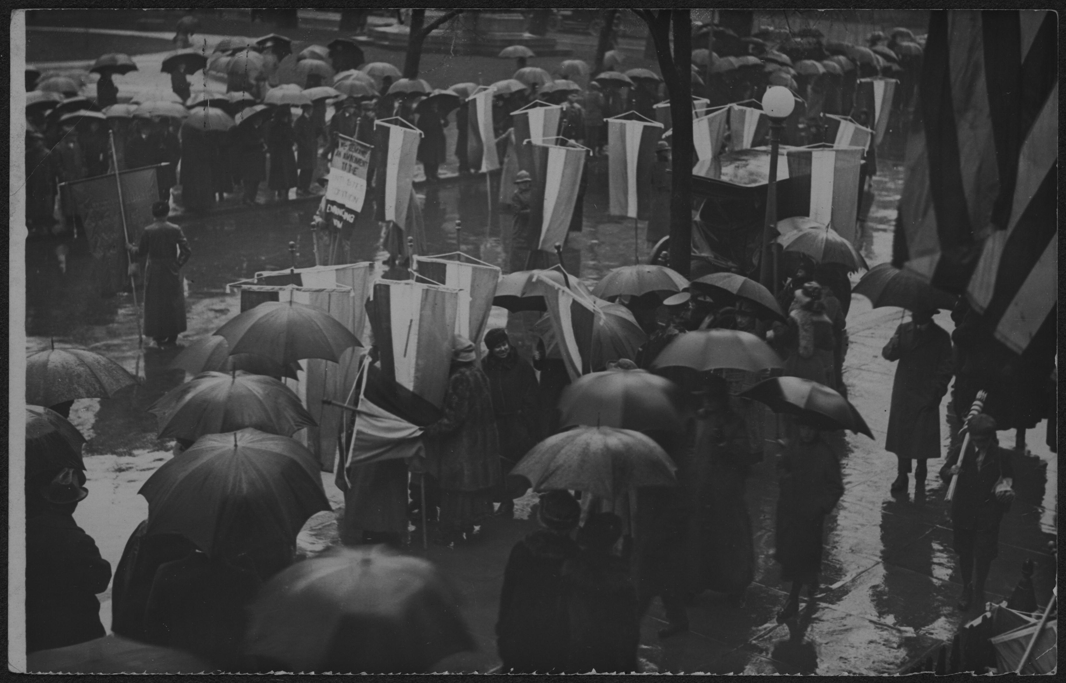 Suffragists picketing with banners in the rain during the Grand Picket, Mar. 4, 1917.